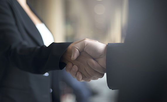 Picture of two business men shaking hands.